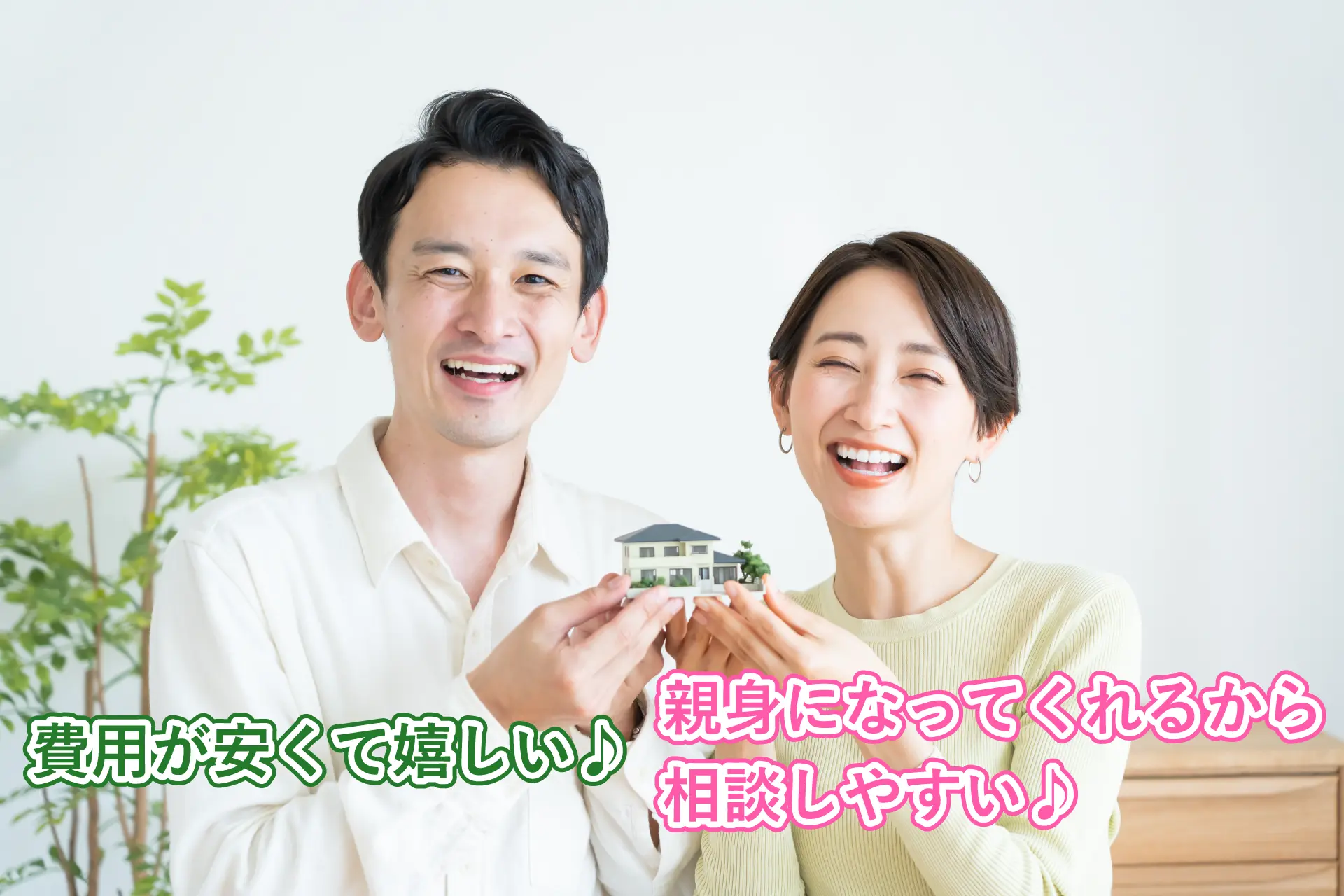 住宅の模型を持つ笑顔の夫婦